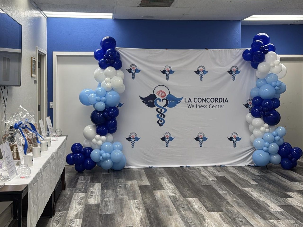 The La Concordia balloon backdrop and silent auction table at the celebration
