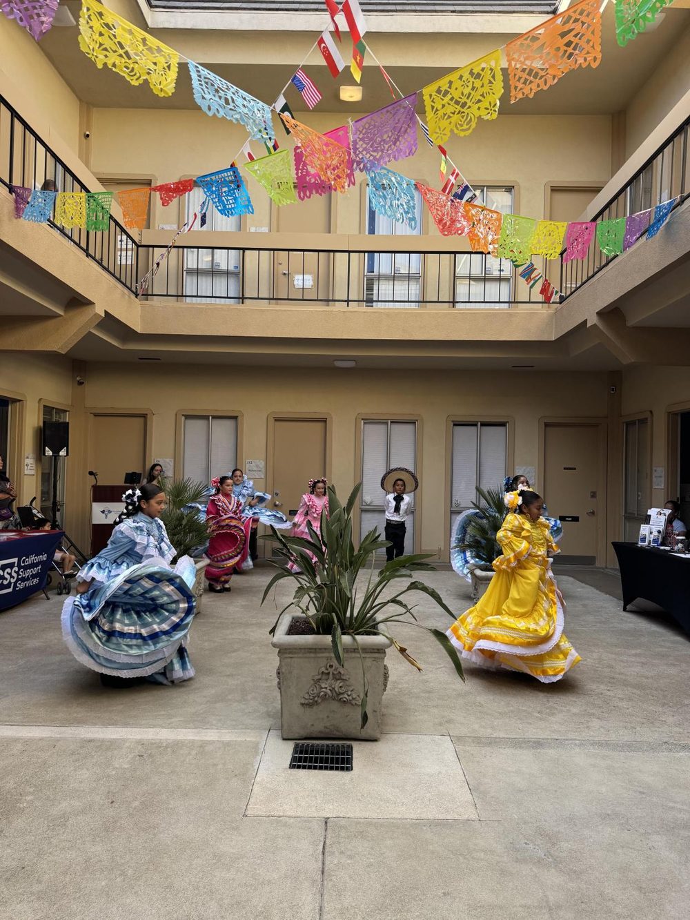 Young folklorico dancers twirling in bright traditional dresses