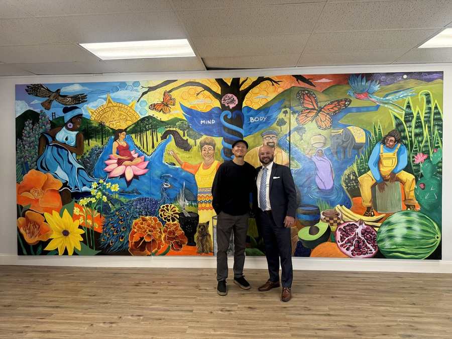 La Concordia staff in front of the Mind & Body cultural healing mural