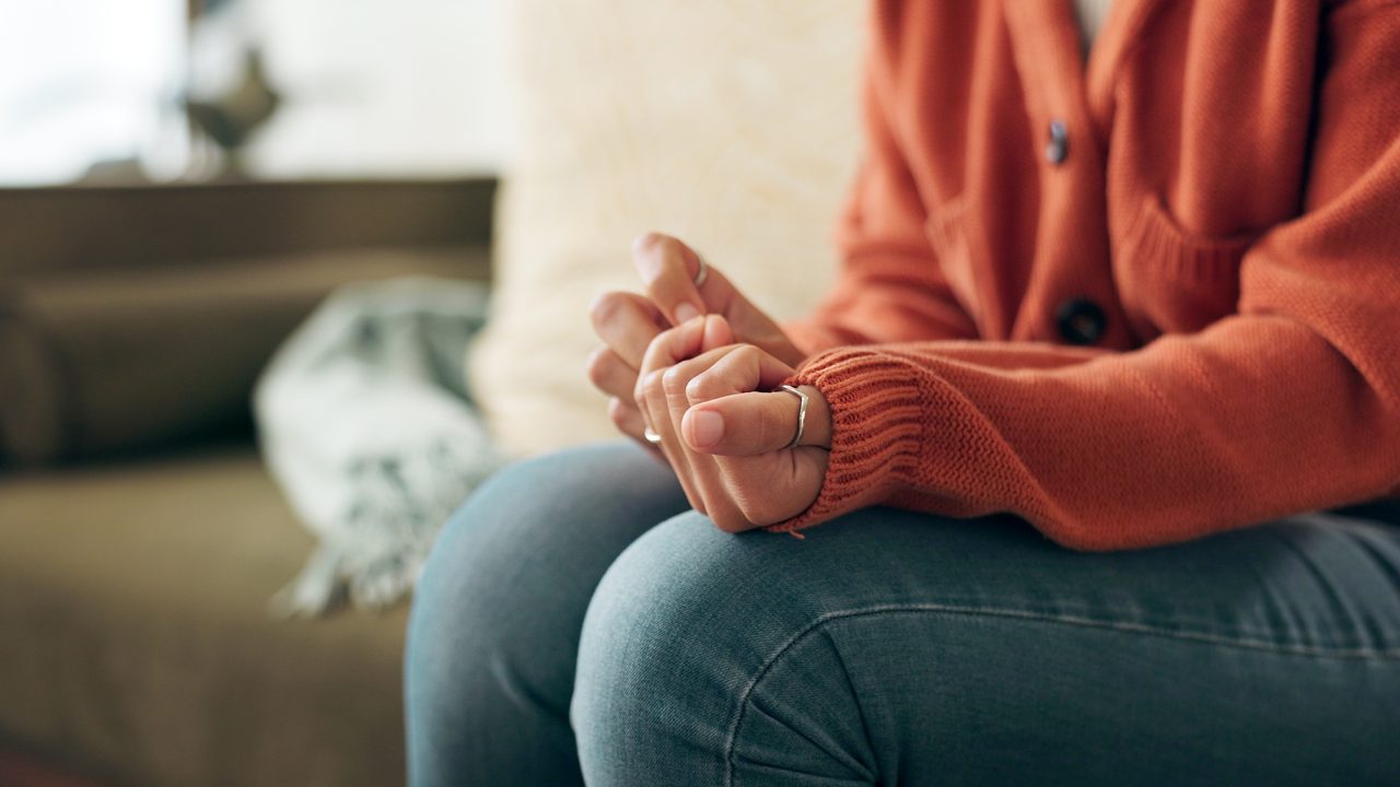 A person's hands resting calmly