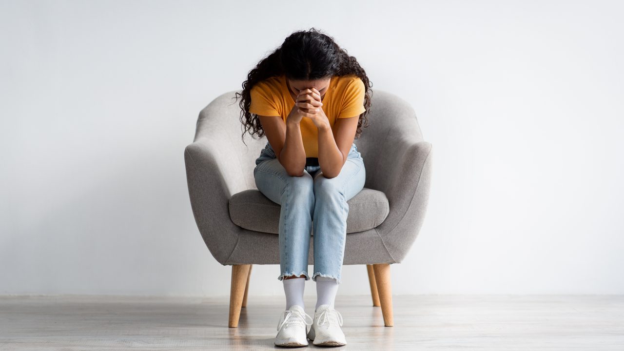 A person sitting with head in hands